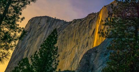 A 'Firefall' moment at the Horsetail Waterfall in Yosemite National Park in California. Each February, when conditions are perfect, Horsetail Fall glows orange and red at sunset (Cover Image Source: Getty Images | Michael Castaneda