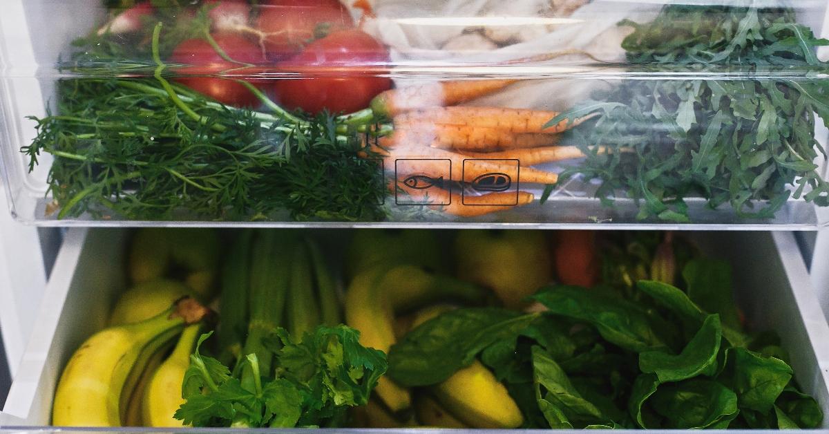 Refrigerator crisper drawers filled with produce.  