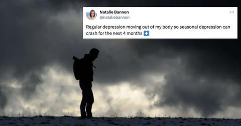 Image of a man hiking under a dark and cloudy sky, with a tweet from Natalie Bannon on top that reads: "Regular depression moving out of my body so seasonal depression can crash for the next 4 months"