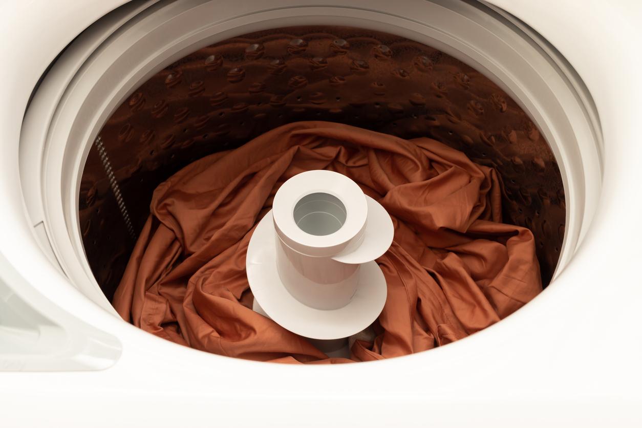 Dark orange blanket inside a washing machine.