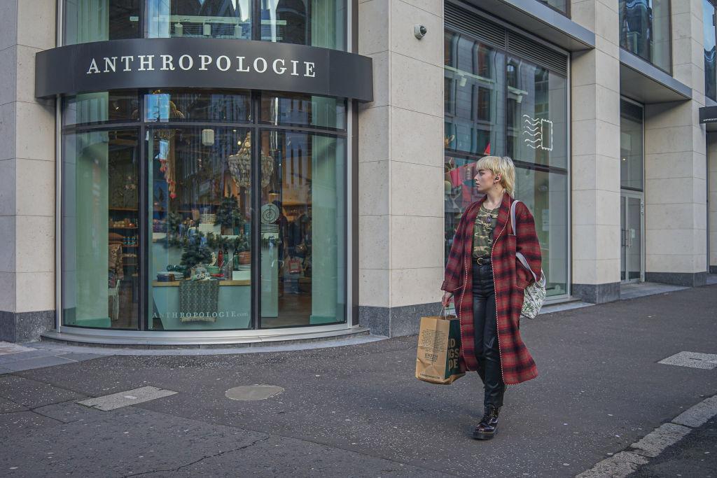 A shopper walks past an Anthropologie store.