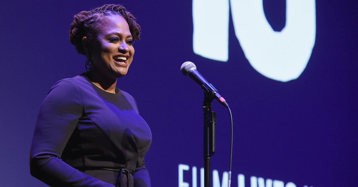 Ava DuVernay smiles as she speaks into a microphone at the 54th New York Film Festival Opening Night Gala Presentation and ‘13th’ World Premiere with Intro and Q&A at Alice Tully Hall at Lincoln Center on Sept. 30, 2016 in New York City.