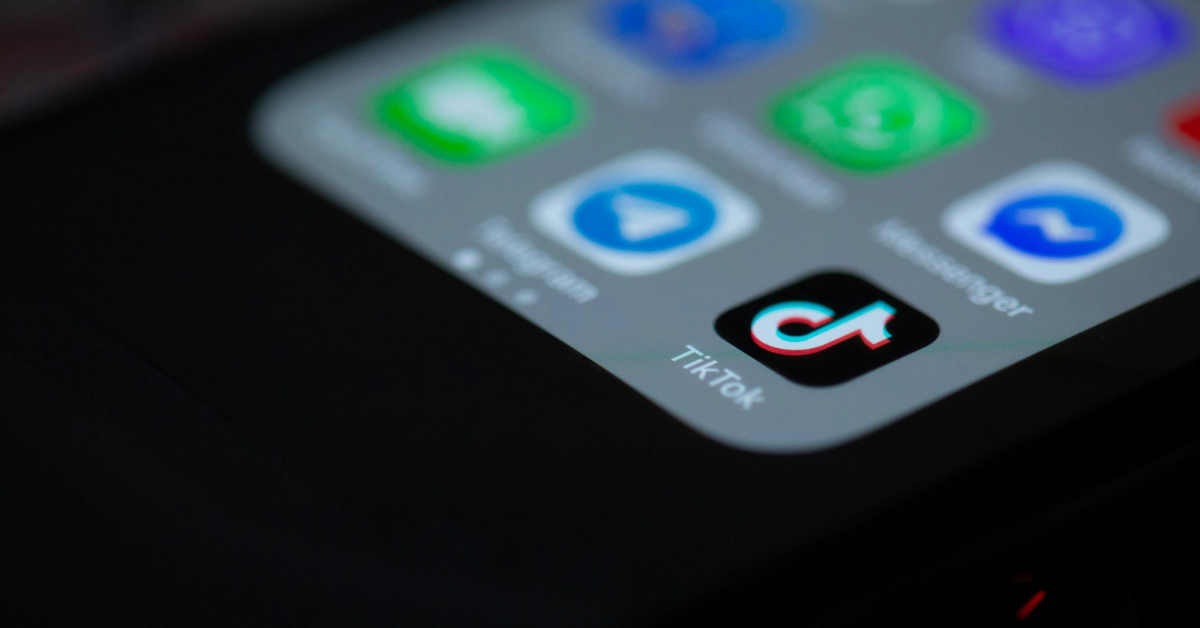 A phone screen shows the TikTok app