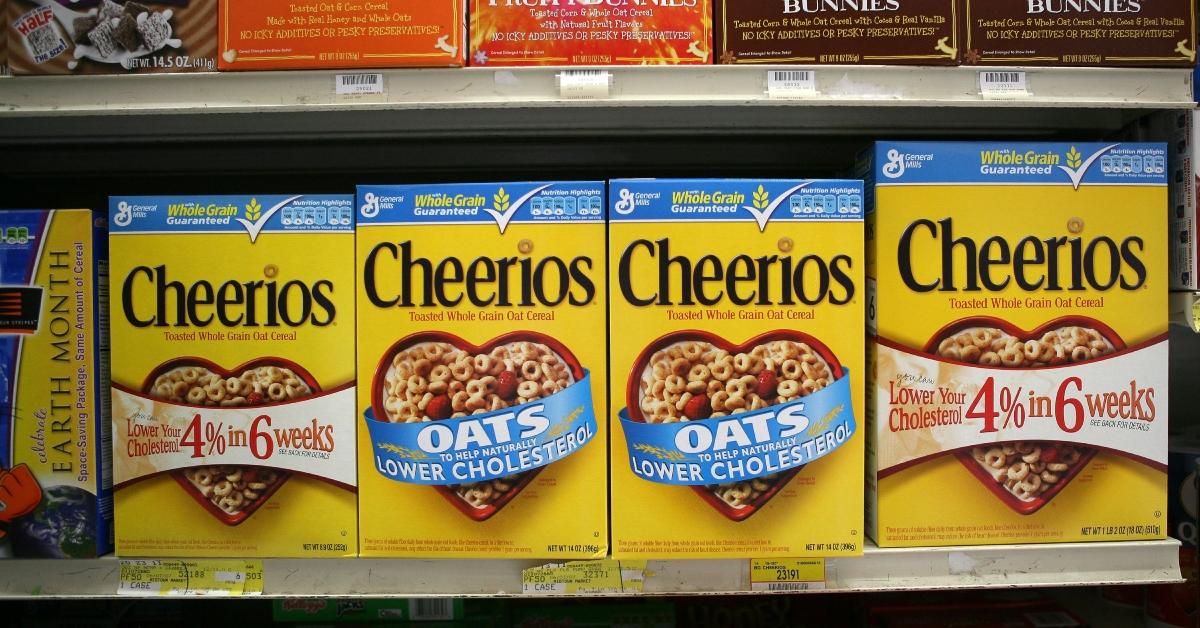 A row of Cheerios boxes on a shelf at the store. 