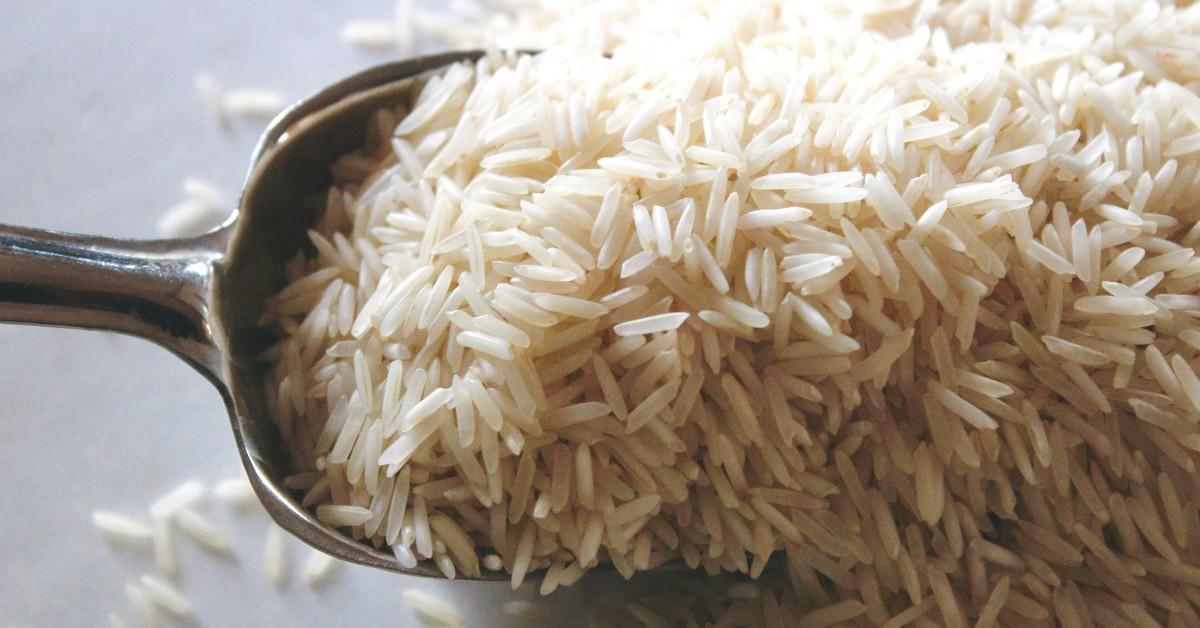 A metal spoon is used to scoop rice
