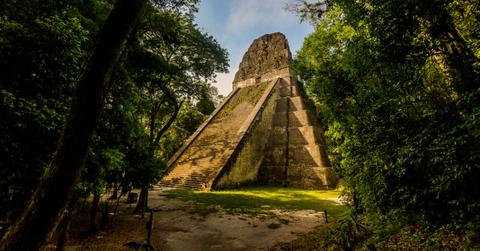 A Maya pyramid and temple stands in the jungle of Guatemala