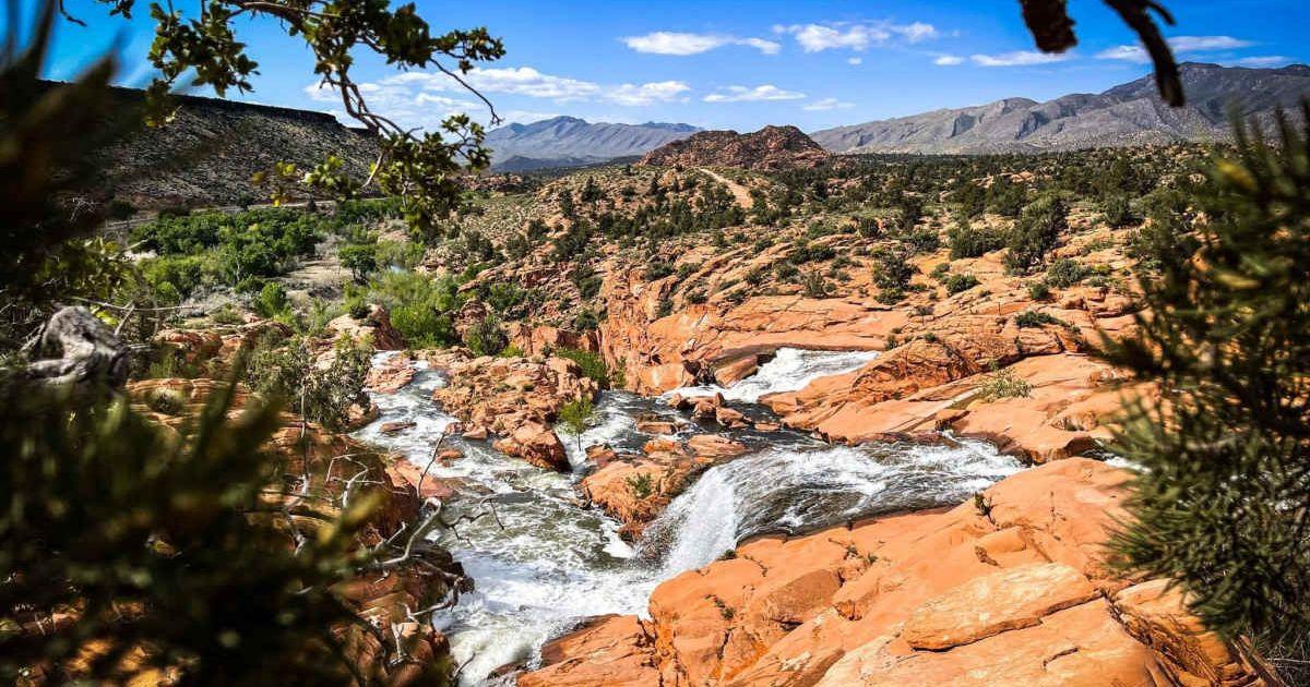 Cascades of foamy water flowing in the rare Gunlock Falls in Southwestern Utah. (Cover Image Source: Facebook | Gunlock State Park)