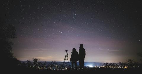 Silhouette of two people watching a meteor shower. (Representative Cover Image Source: Pexels | Yuting Gao)