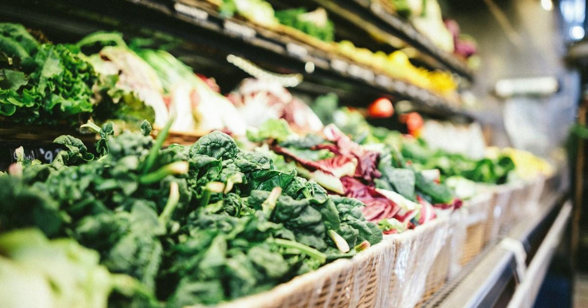 Baskets of produce sit on a grocery store shelf