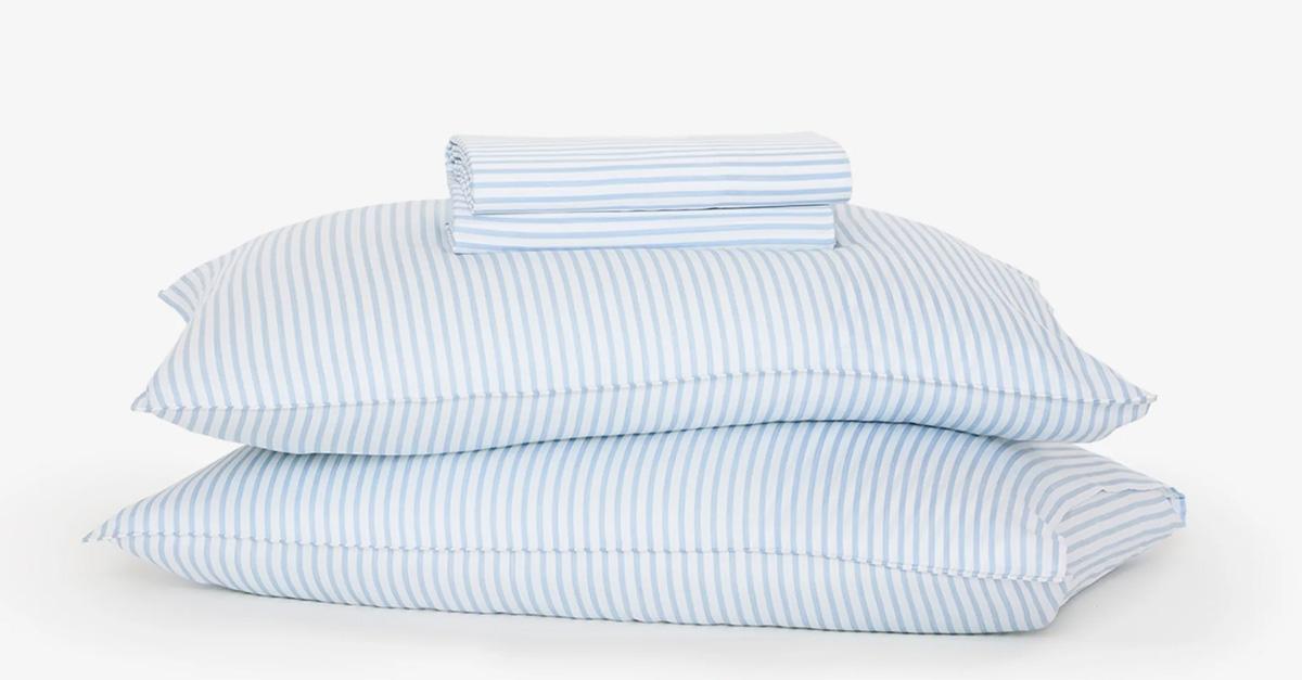 Blue and white striped eucalyptus bed sheets and pillows.