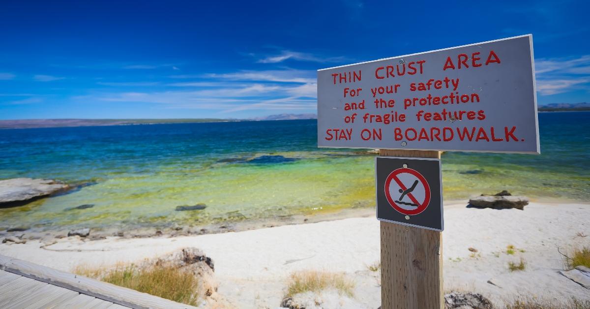 Signs say stay on the boardwalk at Grand Prismatic Springs. 