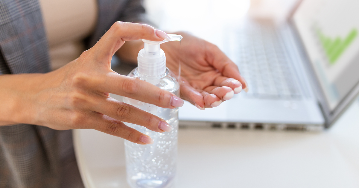 Woman pumps hand sanitizer onto her hands