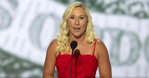 Marjorie Taylor Greene delivers a speech while wearing a red dress