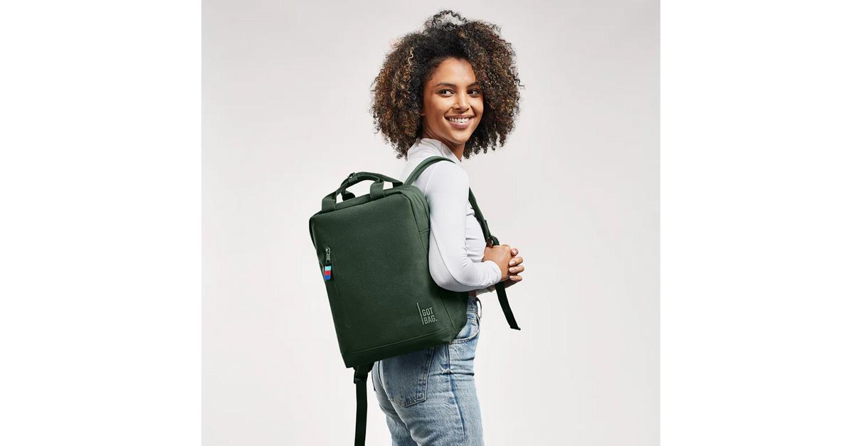 young woman wearing a green backpack