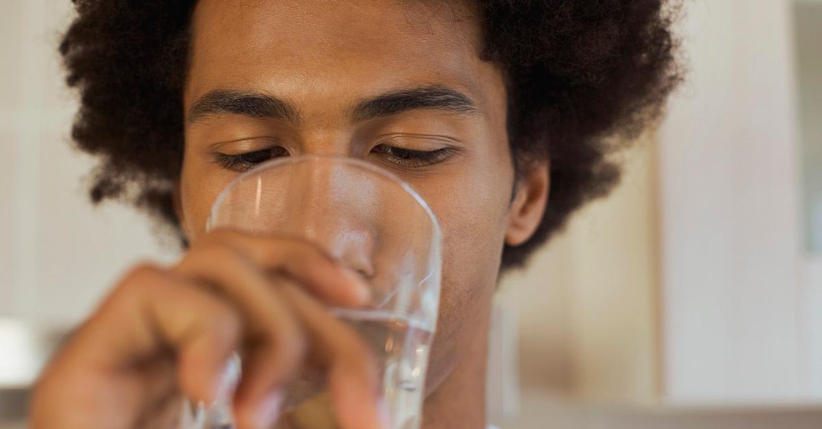 A person drinking water from a glass