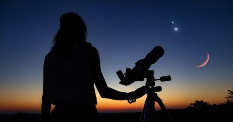 Woman looking at night sky with a telescope (Representative Cover Image Source: Getty Images | m-gucci)