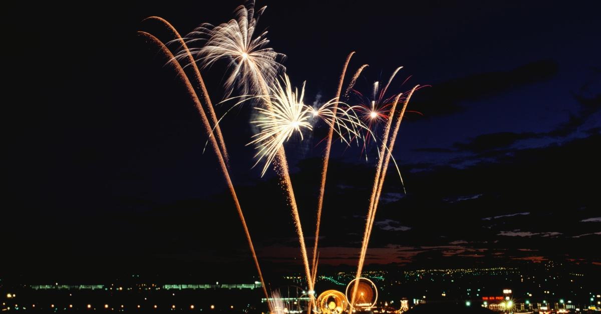 Fireworks in the sky above a darkened city.