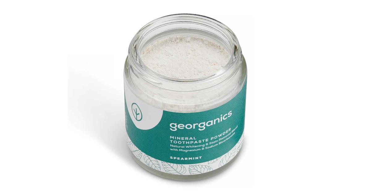 toothpaste powder in a glass tub with green label