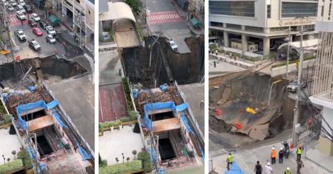 Footage shows a sinkhole appearing in the middle of the road, as workers gathered around