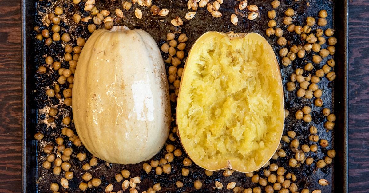 A spaghetti squash cut in half on a baking sheet. 