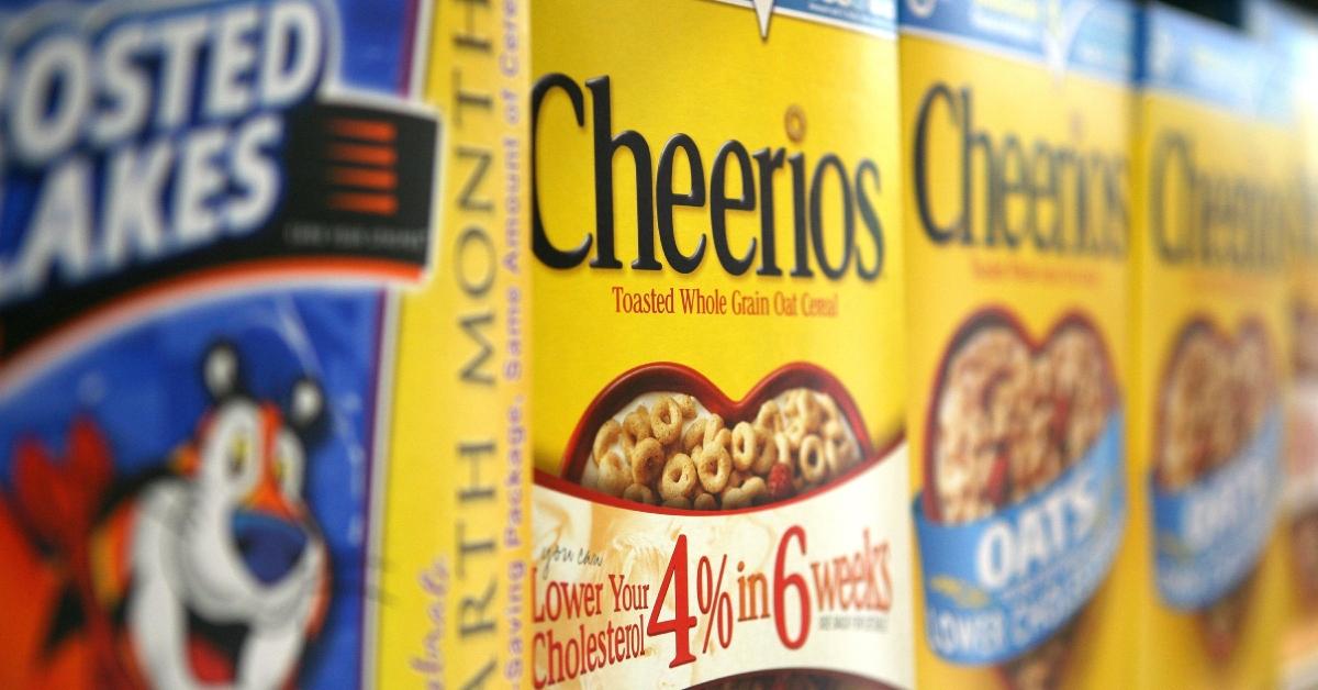 An angled photo of a row of Cheerios boxes next to Frosted Flakes.