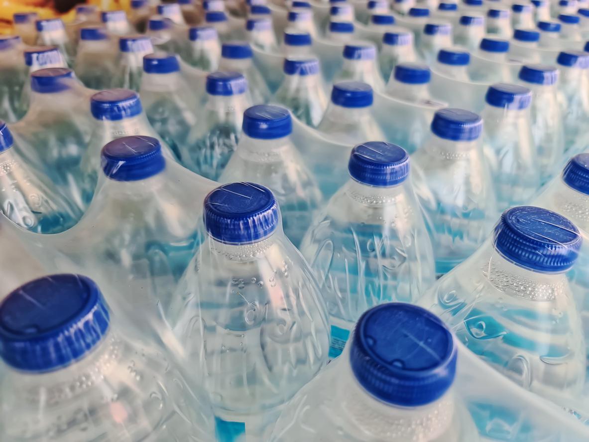 Up close view of brand new packs of bottled water still in the packaging.