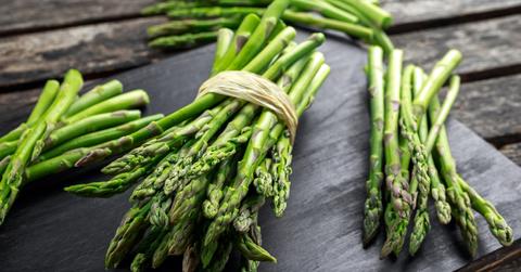 Bunches of asparagus on a wooden table.