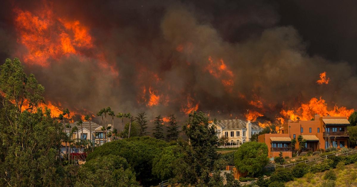 A wildfire near homes. 