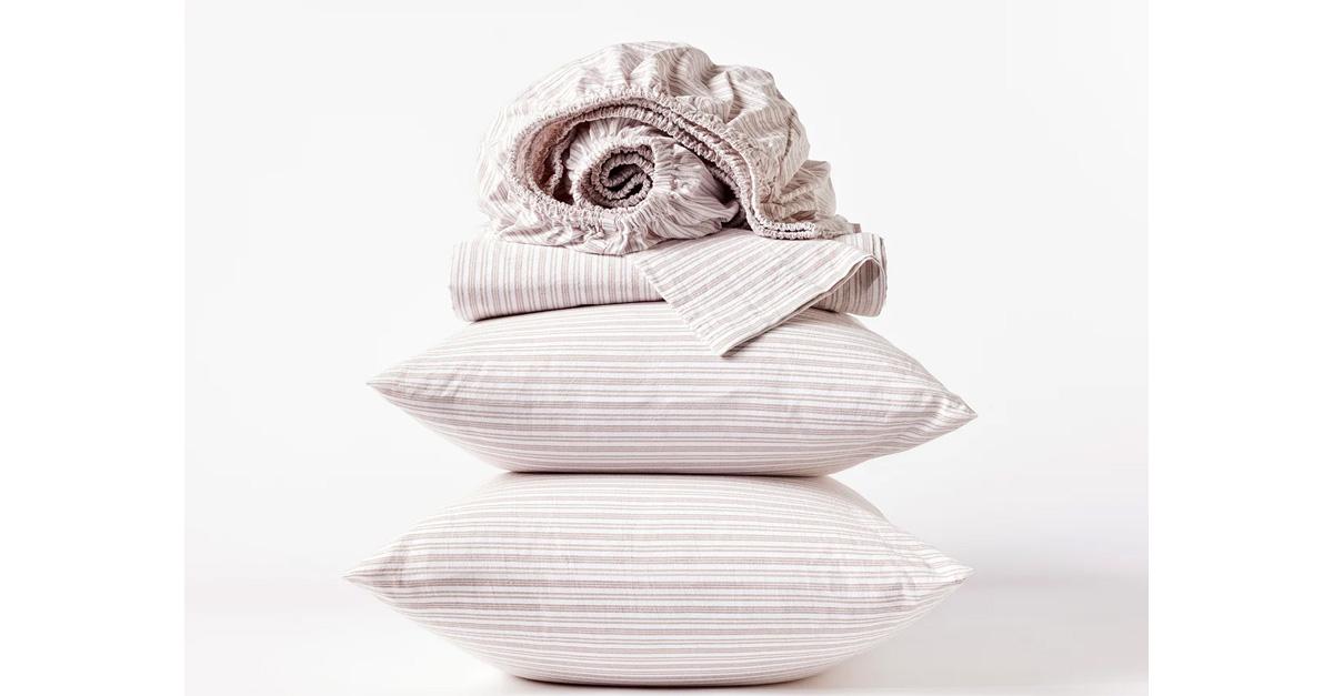 Striped organic cotton bedding set with two pillows.