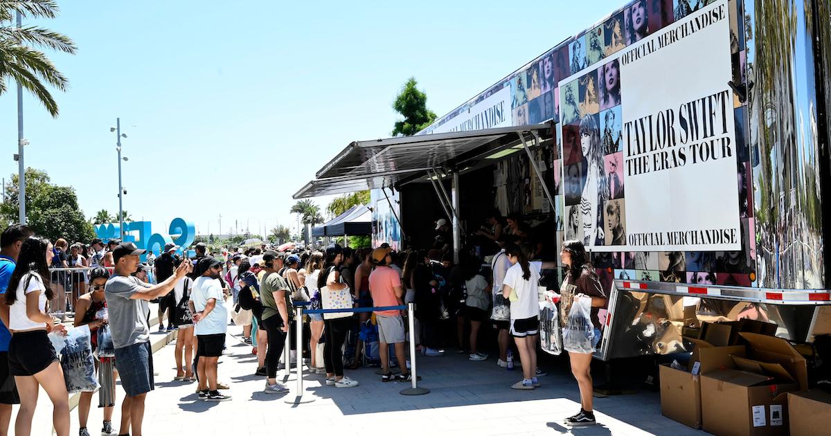 Fans wait in line at an outdoor merch truck to purchase Taylor Swift merchandise at SoFi Stadium in Inglewood on Wednesday, Aug. 2, 2023.