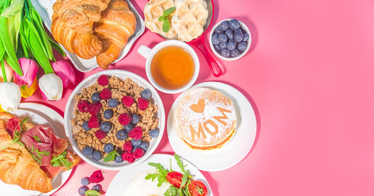 A brunch spread on a pink background.