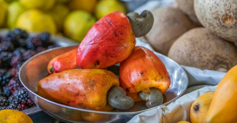 Cashew apples in a tin bowl. 