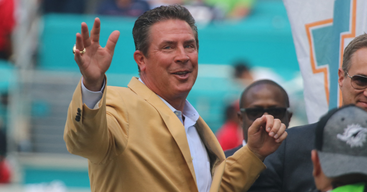 Dan Marino smiles while waving at fans