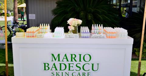 Table featuring Mario Badescu products under a tent outside