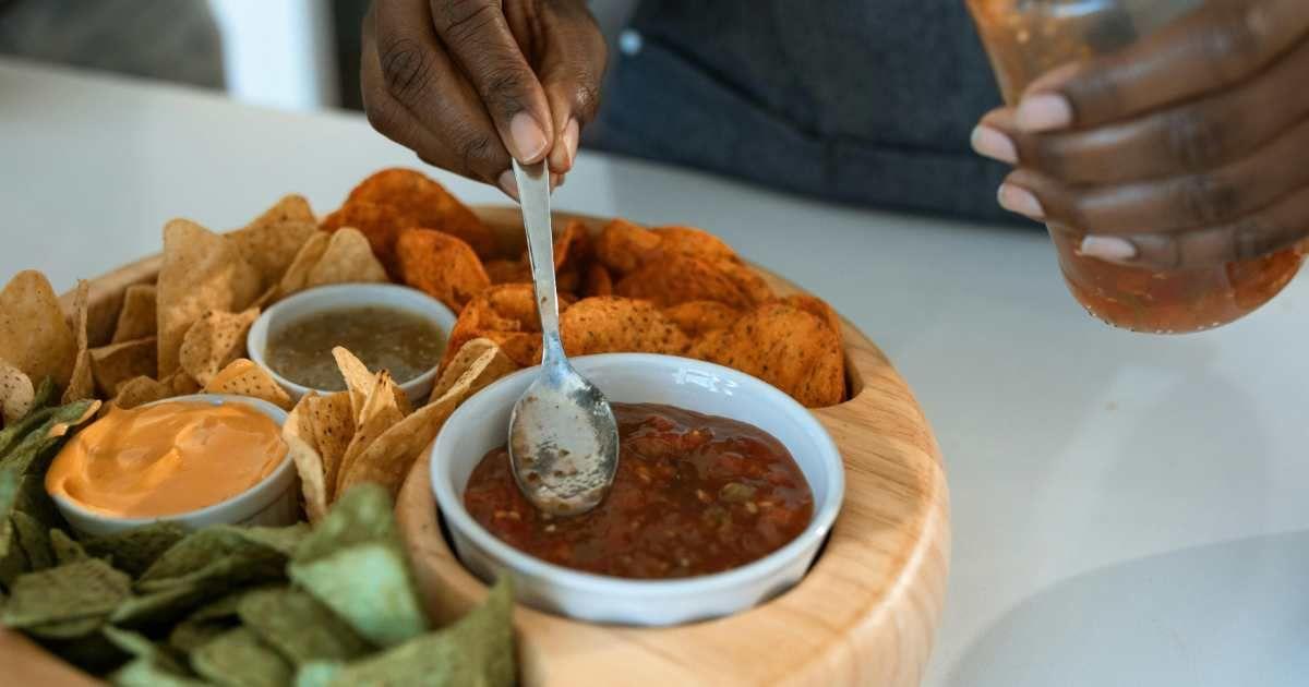 A person eating Nachos with salsa. (Representative Cover Image Source: Pexels | RDNE Stock Project)