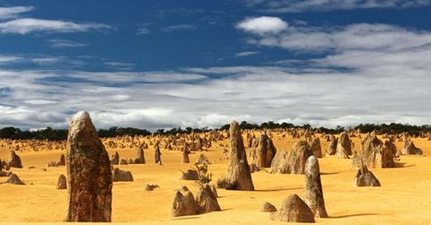 Majestic limestone pillars stick out of the golden sand in Australia's Pinnacles Desert. (Representative Cover Image Source: Unsplash | Tobias Keller)