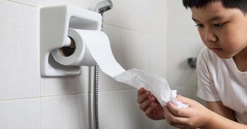 A boy is holding the toilet paper inside a bathroom. (Representative Cover Image Source: Freepik | Jcomp)