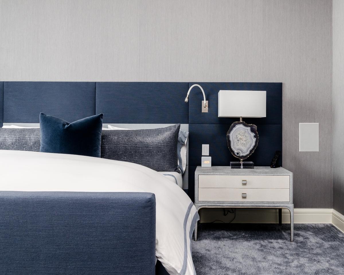 blue and white bed with nightstand