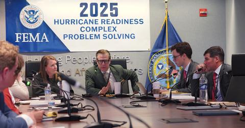 FEMA head David Richardson appears at the center of a FEMA conference table.