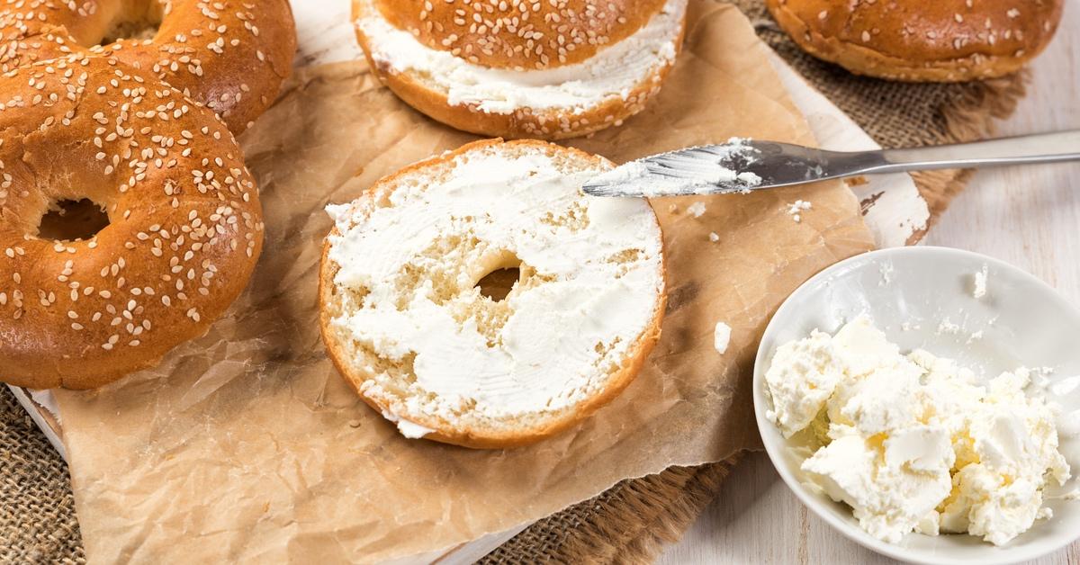 Bagels with spreadable cream cheese on a table