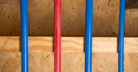 A close up of blue and red vertical PEX pipes.