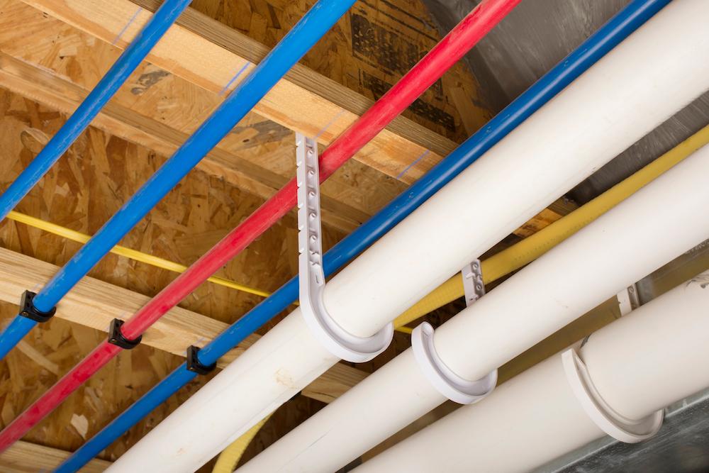 A close up of PEX and drain pipes. 