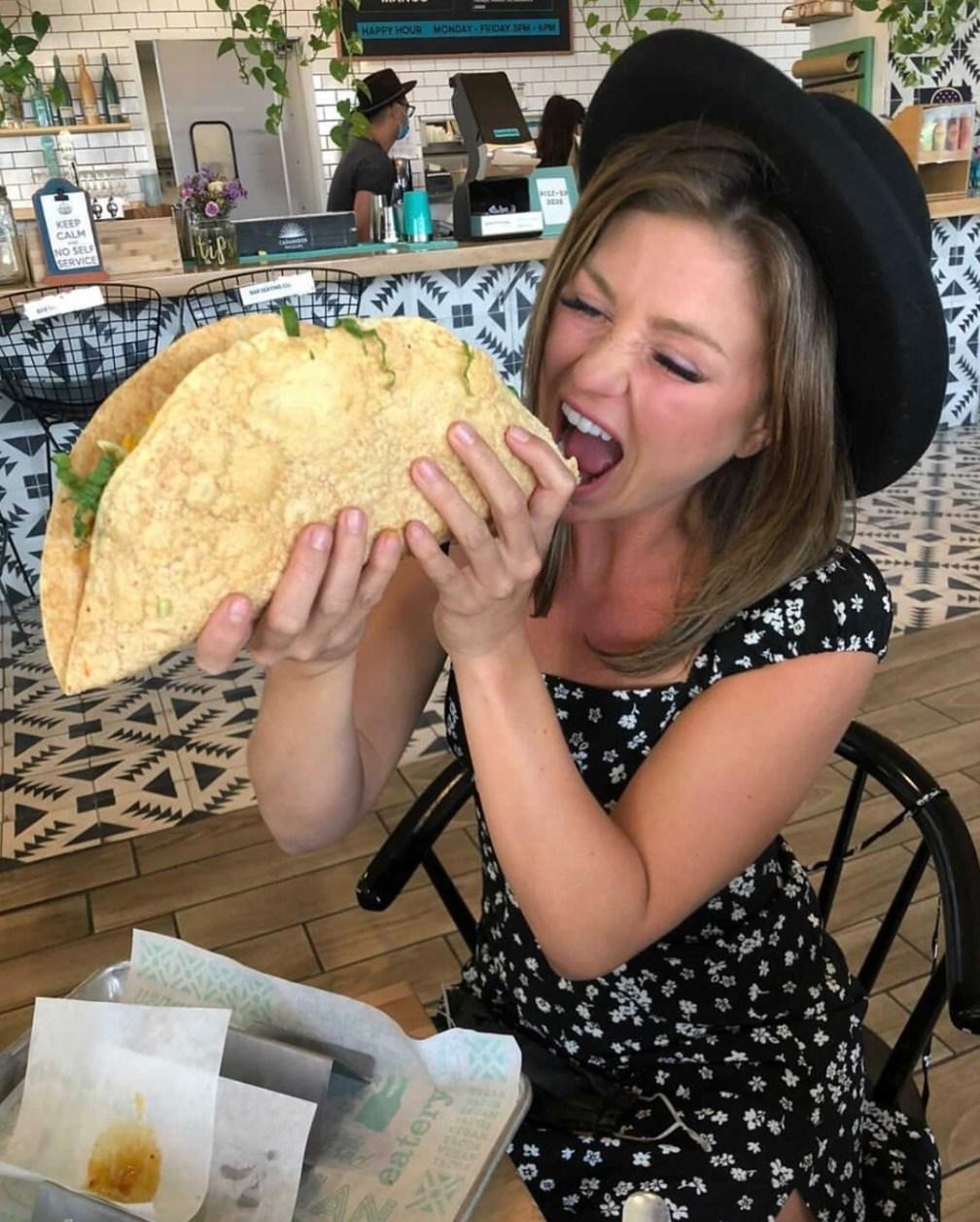 A customer at Tacotarian attempts to eat the largest taco on their menu.