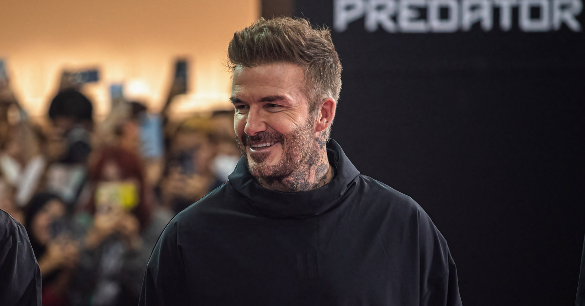 David Beckham wears a black cowl neck top