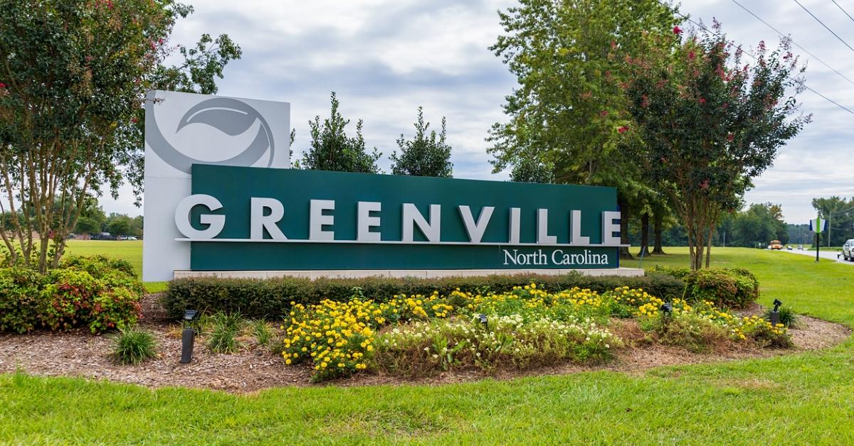 Photo of Greenville, North Carolina, sign surrounded by greenery