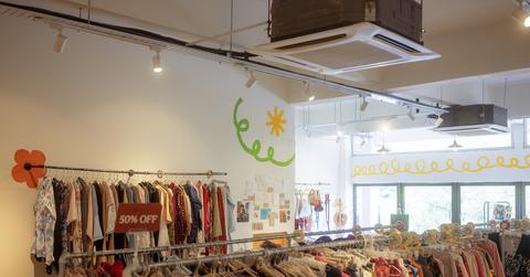 Photo of a local thrift store with two flowers painted on the wall.