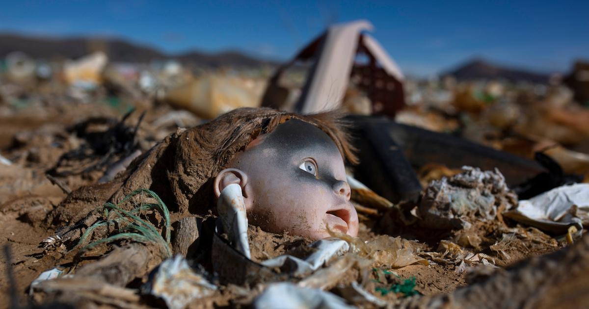 Plastic doll in a landfill