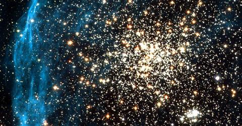 Galaxy cluster glittering with zillions of golden diamond-like stars enguled in a shimmery blue halo (Representative Cover Image Source: Getty Images | NASA)