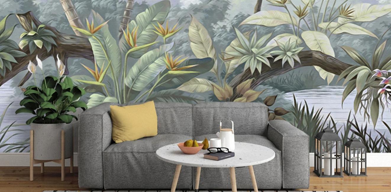 Tropical wallpaper in front of a grey couch. 