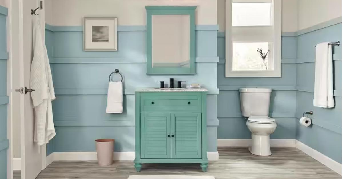 Photo of the Glacier Bay Two-Piece 1.1/1.6 GPF High Efficiency Dual Flush Complete Elongated Toilet in a bathroom with teal and white detailing